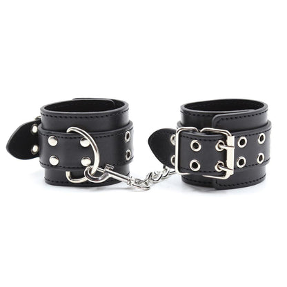 Black BDSM handcuffs with metal studs and buckle