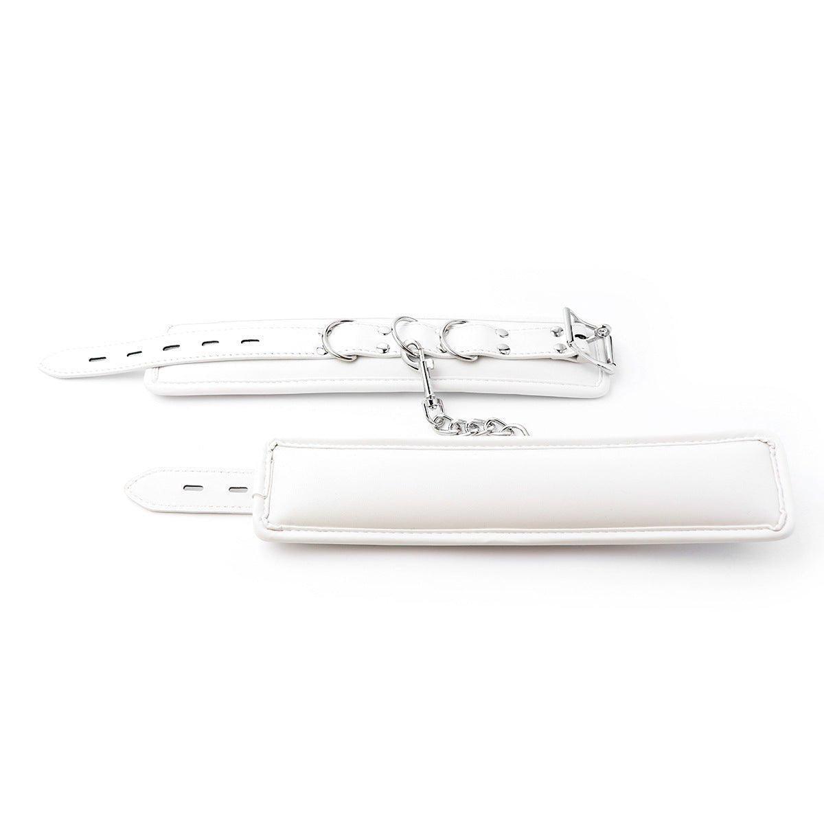 White BDSM wrist restraints with silver chain