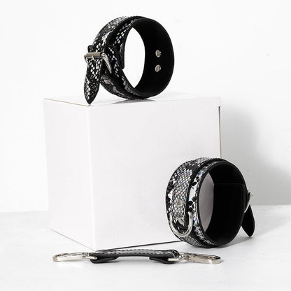 Black snake pattern cuffs on white box